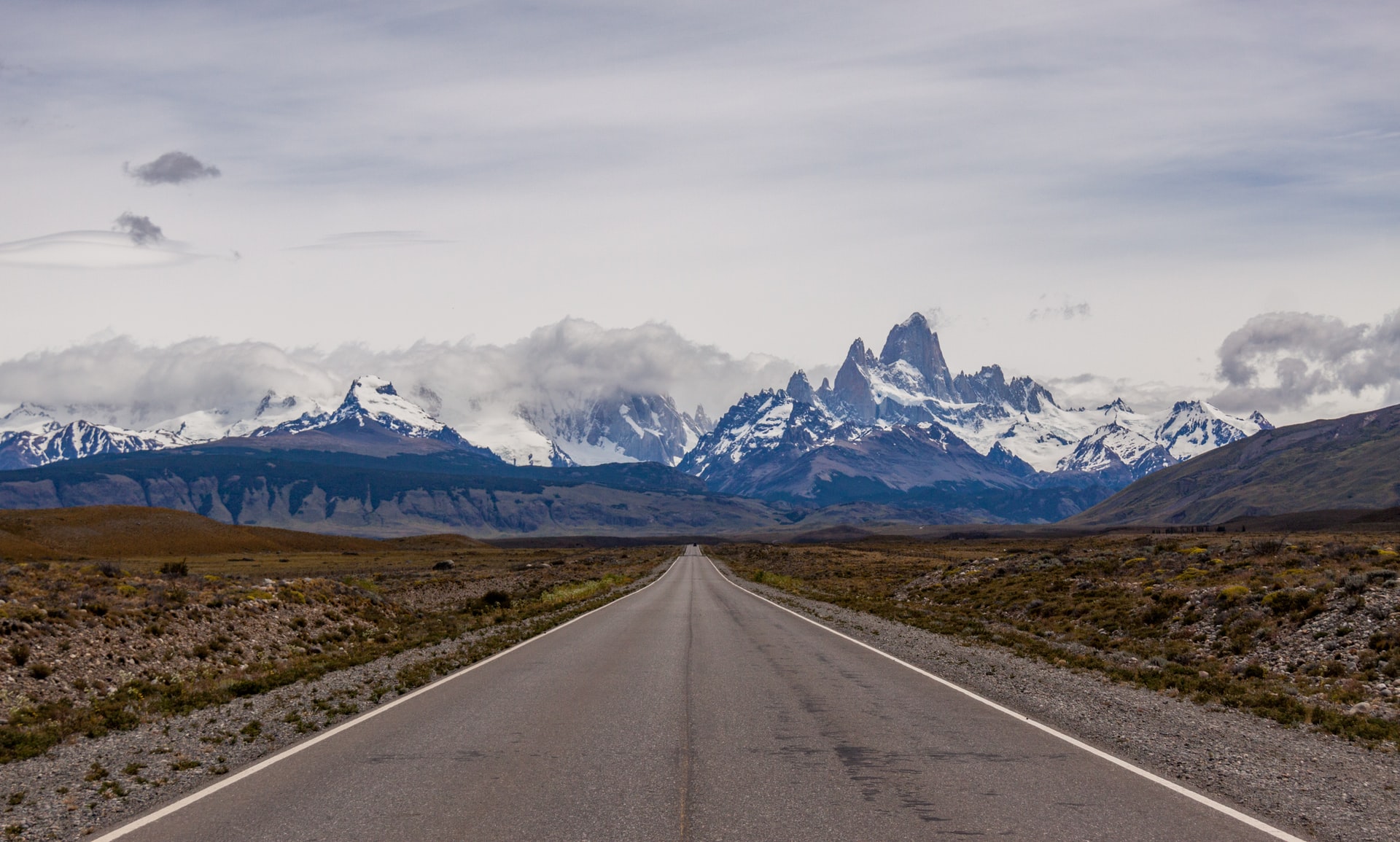 Picture showing a road and the Andes range mountains at the back.