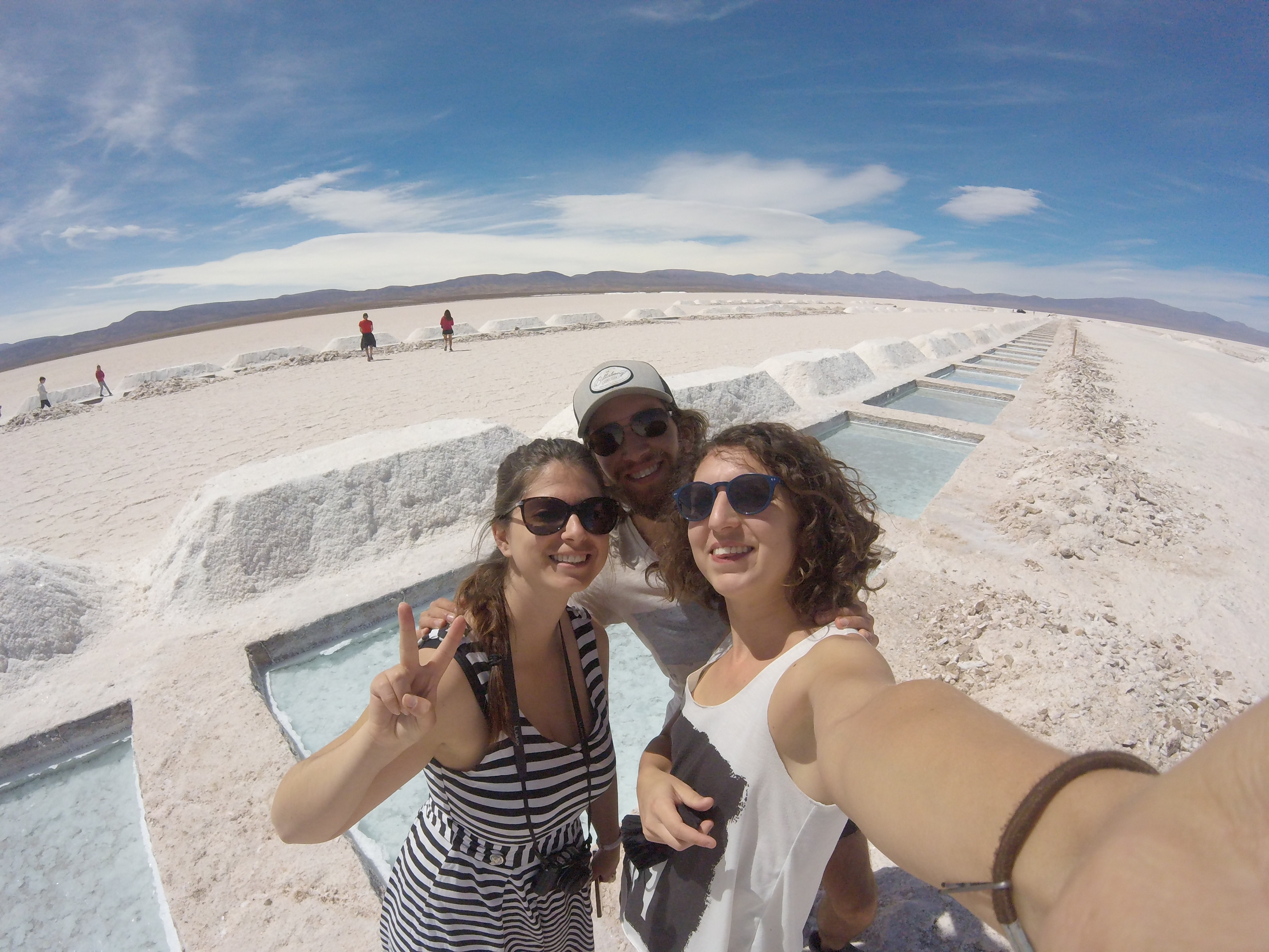 Picture of two French ladies and me smiling at the camera with the landscape of the Salinas Grandes behind.