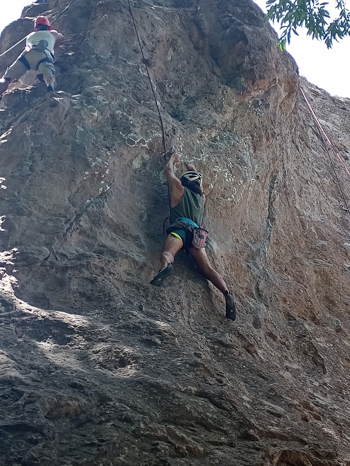 Me holding on to a rock with my fingertips, while top roping.